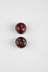 Two cherry plums isolated on white background
