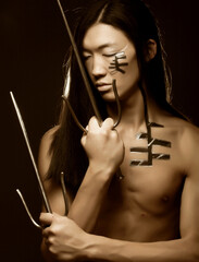 asian boy with weapons © Raisa Kanareva