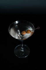 martini with dark background and olive
