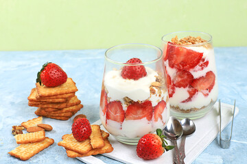 Strawberry yogurt with berries, French cracker and muesli on a bright table, fruit salad. Healthy breakfast with ingredients, natural food concept, lifestyle, food for children, 