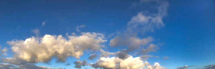 Naklejka na ściany i meble Blue sky white clouds sunset. Panorama.
