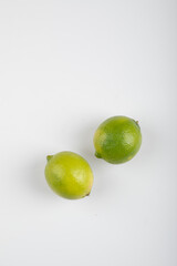Two ripe lime fruits isolated on white background