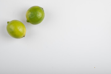 Two ripe lime fruits isolated on white background
