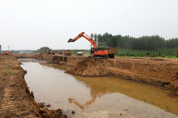 Excavator operation in flood control engineering construction site © zhang yongxin
