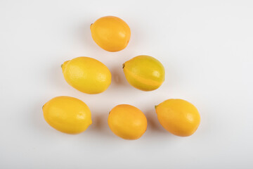 Fresh ripe yellow lemons on white background