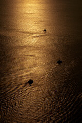 Silhouettes sailboats sailing in Santorini, Greece.