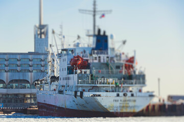 Massive different ship vessels trapped in ice tries to break and leave the bay between the glaciers, icebreaker and carrier vessel, winter blue sky view