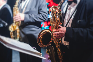 Concert view of a saxophonist, saxophone sax player with vocalist and musical during jazz orchestra...
