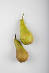 Two whole green pears isolated on white background