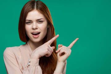 Obraz premium beautiful woman showing finger to side emotion charm cropped view