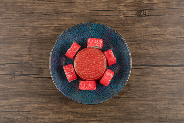 Bowl of sushi rolls and red caviar on wooden table