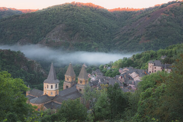 Hillside view of the quaint and charming medieval French village of Conques, Aveyron, a popular...