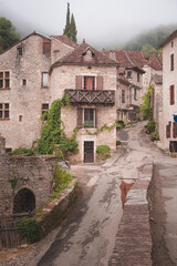 Fototapeta na wymiar The quaint and charming French medieval hilltop village of Saint-Cirq-Lapopie on a foggy, misty morning in the Lot Valley, France.