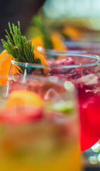 Close up fo Group of Refreshing cocktails with ice and fruits of different flavors and colors in glass on the table on sunny day in front of the sea, beach party in Guanacaste Costa Rica