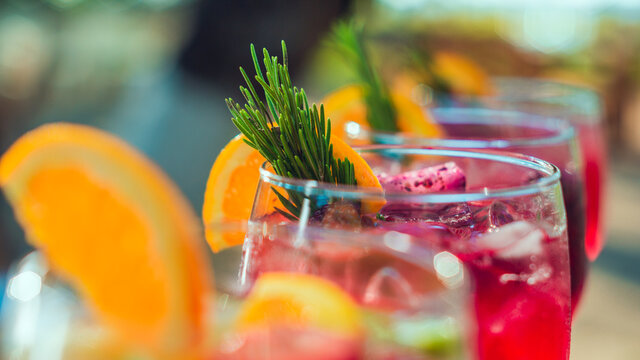 close up of Group of Refreshing cocktails with ice and fruits of different flavors and colors in glass on the table on sunny day in front of the sea, beach party in Guanacaste Costa Rica