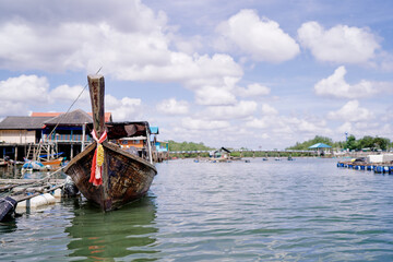Travel by Thailand. Landscape with traditional longtail boat moored on wharf.
