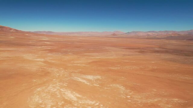 Exploring Atacama Desert vast dry extensions in the driest area of this amazing desert with an all terrain vehicle. An awe road trip adventure crossing the infinite sand extensions from an aerial view