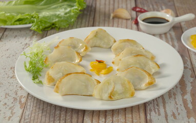 Overhead shot of a plate of handmade fried dumplings, traditional Chinese cuisine