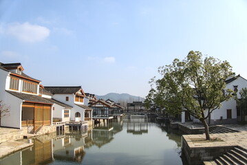 Fototapeta premium Traditional Chinese houses and reflections on the water surface, sunny weather