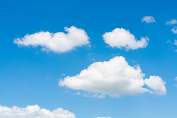 Closeup of white clouds on sunny blue sky background