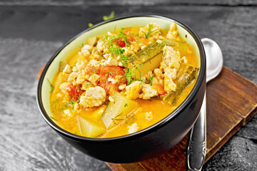 Ragout of zucchini and minced meat in bowl on dark board