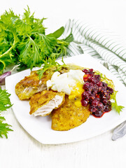 Turkey breast with cranberry sauce on wooden board