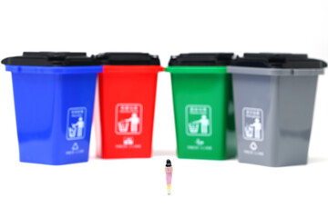 color trash can trash sorting with a woman standing 