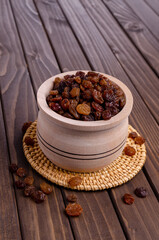 Dark raisins in a wooden dish