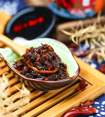 A wooden spoon to scoop up a spoonful of Sichuan chili sauce
