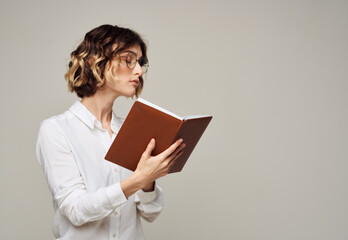Business woman with a book in her hands on a gray background Copy Space