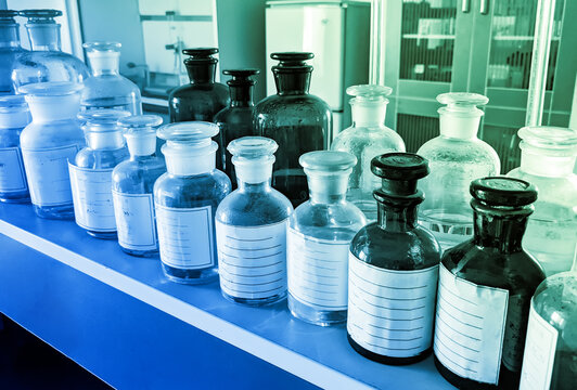 Glass Vials Of Chemical Reagents On A Shelf