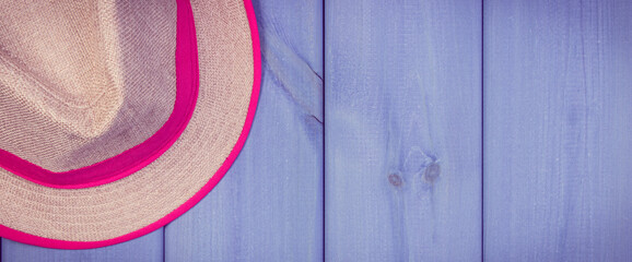 Fototapeta na wymiar Straw hat on wooden boards. Accessories for summer. Copy space for text
