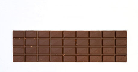 sweet and delicious whole chocolate bar is lying on white background, photo taken from above