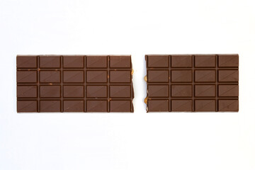 sweet and delicious whole chocolate bar is lying on white background, photo taken from above