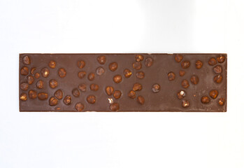 sweet and delicious whole chocolate bar is lying on white background, photo taken from above