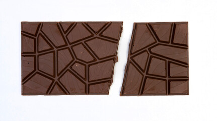 sweet and delicious whole chocolate bar is lying on white background, photo taken from above