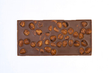 sweet and delicious whole chocolate bar is lying on white background, photo taken from above