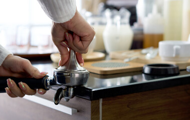 Obraz na płótnie Canvas Barista making fresh espresso coffee. The shopkeeper preparing coffee on counter.