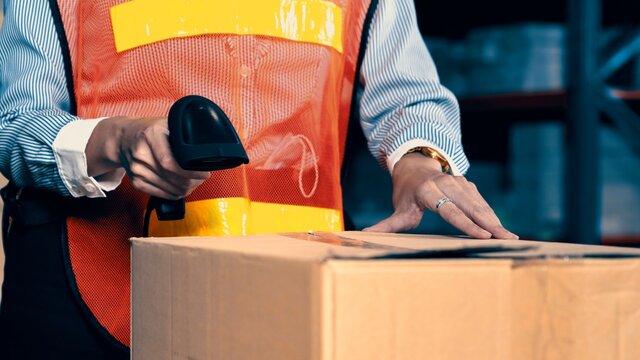 Warehouse worker using barcode scanner in storehouse . Logistics , supply chain and warehouse business concept .