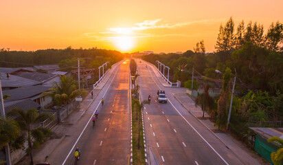 Fototapeta premium The sun rises over Thepsrisin Bridge. Thepsrisin Bridge is a shortcut to connect the city from Saphan Hin intersection with Sakdidet intersection in order to reduce the bad traffic congestion..