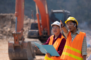 Construction engineers who take care of the progress of construction projects.Supervisors using laptop at construction site