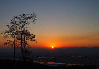 Fototapeta na wymiar Defocused sunset on mountains is a beautiful silhouette background.