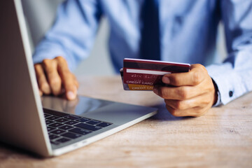 Online payment hands holding credit card and using laptop. Online shopping concept.