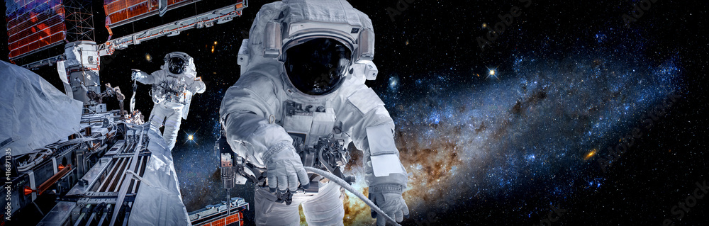 Wall mural astronaut spaceman do spacewalk while working for space station in outer space . astronaut wear full