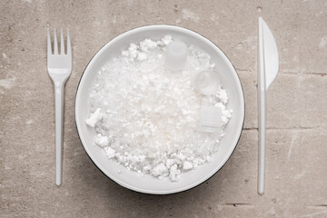 Plastic trash in the bowl and looks like a food. Dangerous food. Sea life problem. Ecology problem.