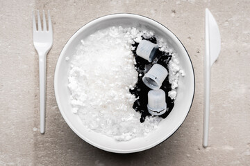 Plastic trash in the bowl and looks like a food. Dangerous food. Sea life problem. Ecology problem.