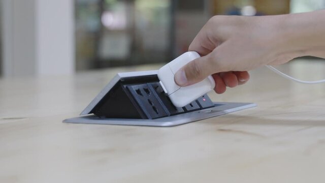 Pop-up power plug, man's hand held the plug into the outlet ,Unplugging after use, Opening of electrical circuits or plugging in electrical outlet,4K Footage 24 FPS.