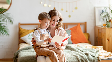 Mother and son reading greeting card