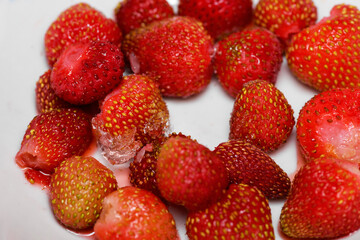 Frozen strawberries covered by frost, berry Victoria, close-up. Berry in ice