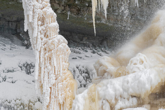 Close up shot of beautiful frozen Valaste waterfall, Northern Estonia. Selective focus.